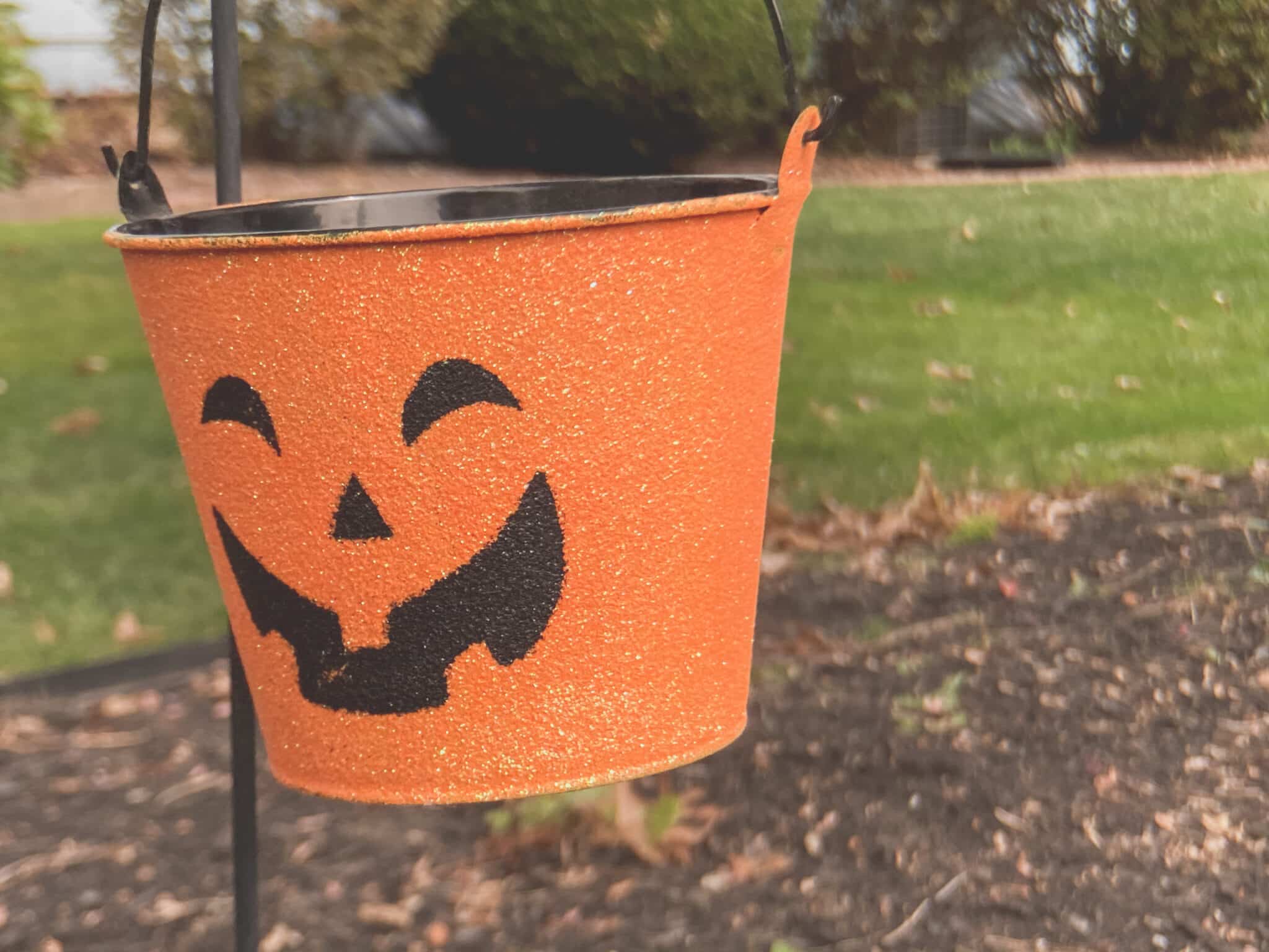 An orange pumpkin themed Halloween tin.