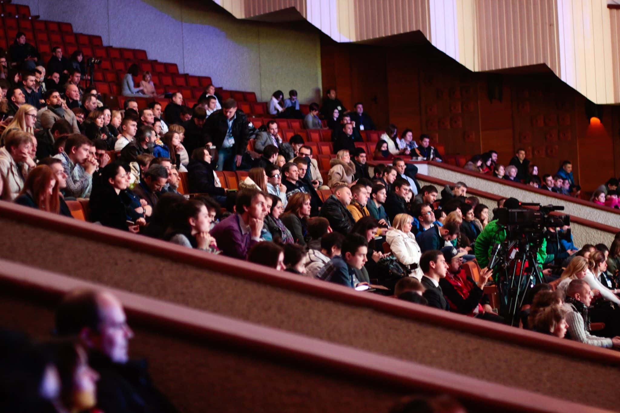 public-events-auditorium-crowd-hearing-loops Group of people watching a performance in an auditorium.