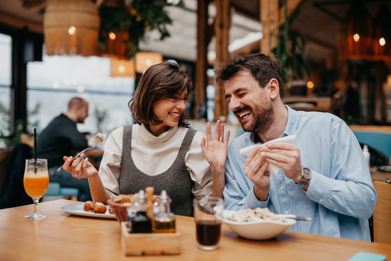 Two friends having dinner together.