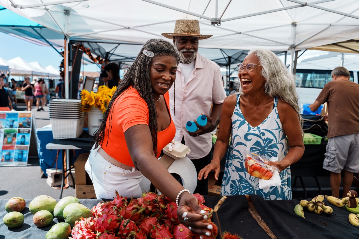 Three senior friends hanging out at a farmers market