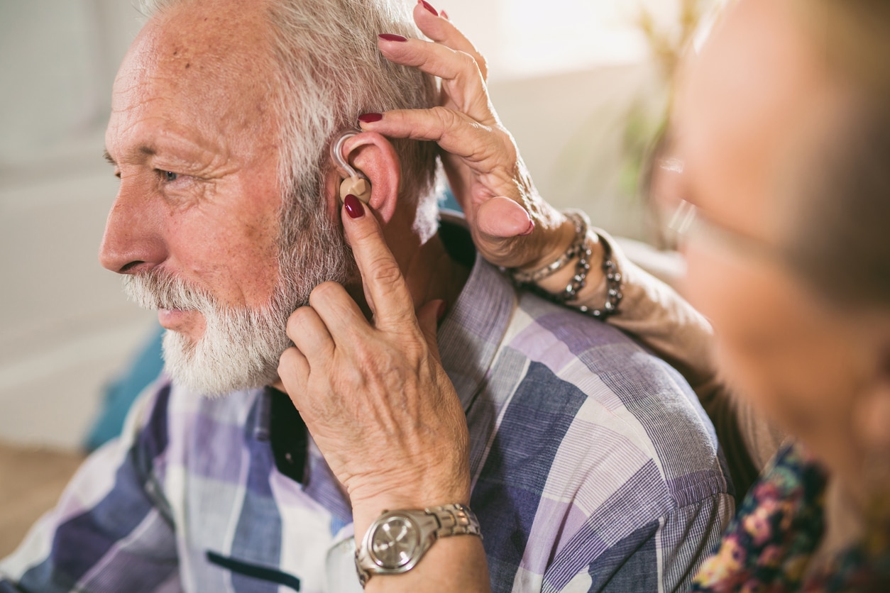 Senior man getting a new hearing aid