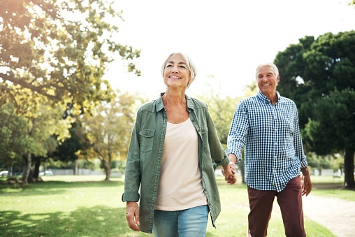 Happy couple going for a walk in the park.